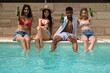 © Ladanifer - Group of young tourists enjoying a refreshing drink by the pool during summer vacation