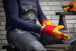© Sergey - Close-up of construction worker putting on protective gloves. Concept safety equipment.