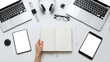 © Dhamar - Top-down view of a clean workspace with two laptops, tablets, headphones, glasses, and an open notebook, ready for productivity