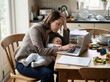 © lunarts_studio - Stressed working mother juggling career and baby while working from home.