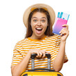 © Damir Khabirov - Excited female tourist with yellow suitcase celebrating holding passport and tickets for vacation trip