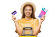 © Damir Khabirov - Happy female tourist with suitcase holding credit card passport and tickets for travel booking payment