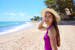© zigres - Portrait of young woman with straw hat on Maceio beach, Brazil. Looks at camera.