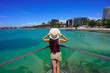 © zigres - Vacation in Brazilian Caribbean. Young tourist woman on viewpoint in the city of Maceio, Alagoas, Brazil.