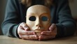 © Vadym - Person holds wooden mask revealing face. Concept of identity change, inner self, and authentic expression. Revealing truth, overcoming deception, or starting anew.
