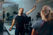 © nicoletaionescu - Woman Struggles with Elastic Arm Band Doing Exercises. Patient using rehabilitation equipment for functional fitness