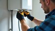© Pete - Plumber installs new hot water heater in utility room. Worker with gloves connects pipes to appliance. Home service, domestic repair, domestic maintenance. Heating system upkeep.
