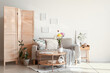 © Pixel-Shot - Interior of living room with sofa, folding screen and ikebana on table