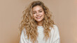 © Shelley - Cheerful Young Woman with Curly Blonde Hair Smiling in White Sweater Against Beige Background for Fresh and Inspiring Branding