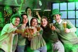 © Pixel-Shot - Group of young people with beer celebrating St. Patrick's Day in pub