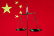 © Max Zolotukhin - Golden scales of justice against the backdrop of the Chinese flag