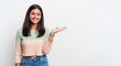 © Tarunkumar - Indian College Girl with Welcoming Gesture on White Background