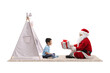 © Ljupco Smokovski - Santa Claus giving a present to a little boy in front of a kids tent