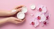 © topan - Womans hands displaying cosmetic cream with delicate orchid flowers