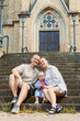 © DSMT - Family poses on steps of church with child during daylight in town setting while smiling and enjoying time together outdoors