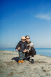 © DSMT - Child and adult enjoy time by the water on a sunny day at the beach with blue skies and clear conditions