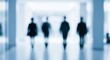 © imammudzakir - Blurry silhouettes of people walking in a bright modern corridor with white pillars and shiny floor