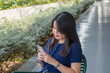 © Khiem - An asian woman is using her phone, call, text, video call, selfie. Connection and sharing concept. Stock photo
