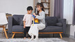 © 220 Selfmade studio - Asian family mother and son having happy time playing together in living room with love and care feeling relaxed