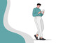 © koncone - Stylish young man standing and using smartphone with focused expression in casual attire in a