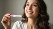 © ArtFocus Studio - Emotional young woman smiling and crying with joy while holding a positive pregnancy test, celebrating the news of motherhood in a soft lit indoor setting.