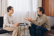 © anatoliycherkas - Psychologist listening to man during mental health therapy session