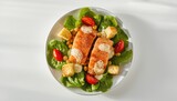 Salmon atop Caesar salad, highlighting fish as a healthy protein source in a cold dish, ideal for seafood cuisine, World Oceans Day