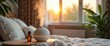 © IvaNad - Essential oil diffuser set on rumpled bed linen, bedtime relaxation and personal sanctuary comfort