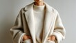 © LifeFree studio - Minimalistic fashion portrait in Color of the Year Cloud Dancer, woman wearing cozy textured oversized coat and knitted sweater in soft neutral tones