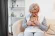 © Serhii - Senior woman with photographs at home