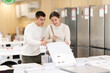 © JackF - Young couple shopping at home appliance store choosing dishwasher or washing machine