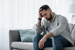 © Prostock-studio - Attractive guy feeling desperately, sad, looking worried depressed thoughtful and lonely suffering depression on couch at home in middle age crisis, mental health personal problems and lifestyle