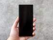 © Jumpei - 手に持ったスマートフォンの空白画面が操作や表示待ちを示すシンプルなイメージ