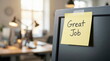 © CK Studio - 'Great Job' message on a yellow sticky note attached to a computer monitor in a bright, modern office, symbolizing appreciation and success.