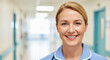 © Hifzhan Graphics - A friendly middle-aged female nurse smiling warmly, wearing clean professional nursing uniform