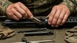 © AudaX - Soldier's hands cleaning a disassembled rifle with a brush and tools.