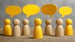© Atchariya63 - Wooden figure standing out with yellow speech bubble, communication concept, group discussion, leadership and teamwork idea