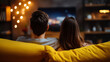 © Secrets inside - A couple sitting closely on a yellow couch watching TV in a cozy, dimly lit living room with warm decorative lights in the background