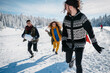 © Halfpoint - Group of friends enjoying winter time in snowy nature.