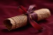 © Iryna - Ancient manuscript scroll with red ribbon on velvet cloth