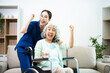 © Nuttapong punna - Asian nurse caring for smiling elderly woman in wheelchair at home. Senior care, home healthcare, nursing support, compassion, caregiver service concept