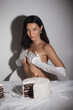© Buyanskyy Production - Seductive Topless Woman in Gloves Posing with Birthday Cake in Shadows