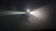 © changshan - lighthouse. A lighthouse beam piercing dense fog at night along the coastline. travel magazines, destination branding, designed for outdoor magazines and nature guides, used by radiologists.