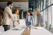 © BusinessClass by W61 - Business team discussing project at table in modern office
