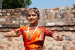 © RooM The Agency - Portrait of a Smiling teenage girl performing the Bharat Natyam traditional Indian dance