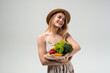 © Volodymyr_sh - Young woman holding reusable mesh shopping bag with fresh vegetables and fruits, sustainable grocery shopping, eco friendly lifestyle, healthy food choices and conscious living concept