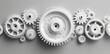 © Xiaoxiao - Multiple white gears with intricate teeth arranged on grey background, showcasing mechanical precision and orderly internal structure in sharp focus.