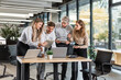© ty - Group of young modern people in formalwear using modern technologies while working in the creative office
