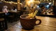 © ngamaz - Traditional Indonesian Wedang Uwuh herbal drink served in a rustic clay mug on a wooden table in a cozy cafe with blurred background.