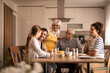 © Jelena - Multi-generational family enjoying a joyful lunch together